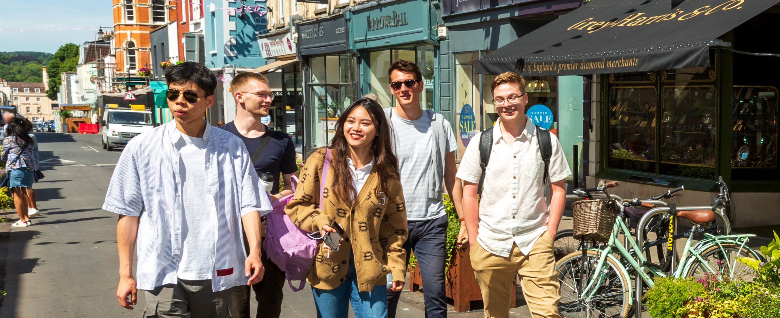 Group of five students walking in Clifton Village
